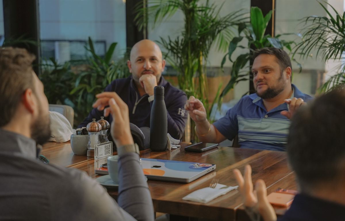 Members in conversation around a table at the clubhouse