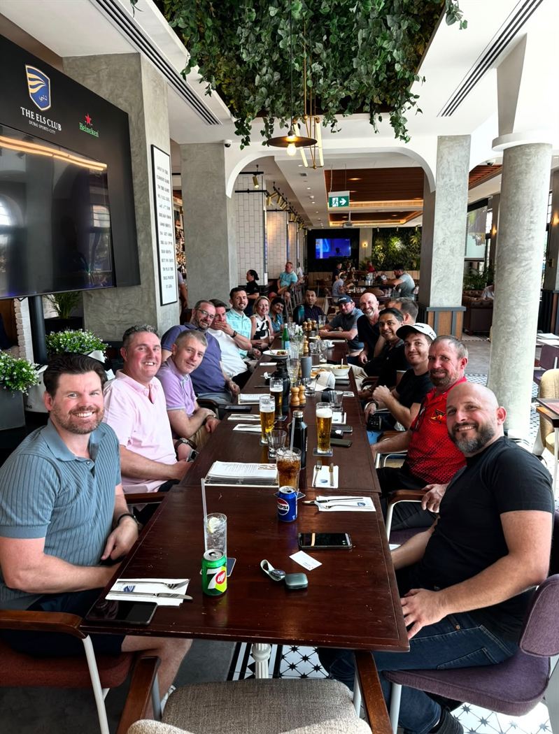 Members around a long table for lunch at The Els Club, Dubai Sports City