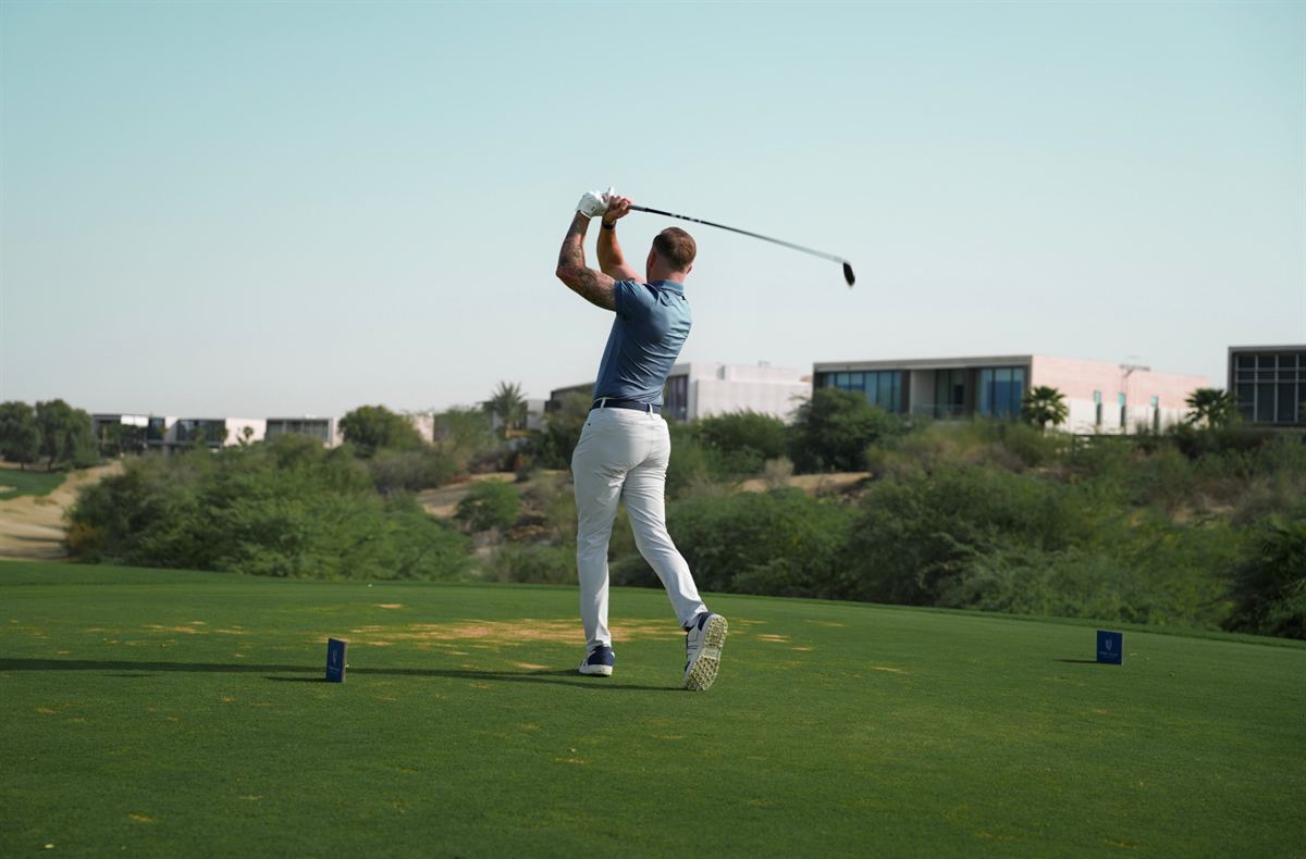 A member watching his drive from the tee at Dubai Hills Golf Club